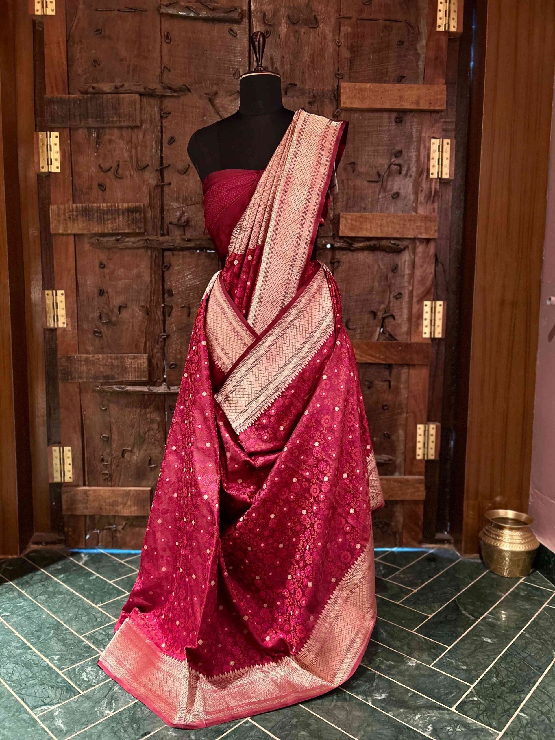 Maroon Tanchoi Banarasi saree with a floral weave and rose gold detailing.