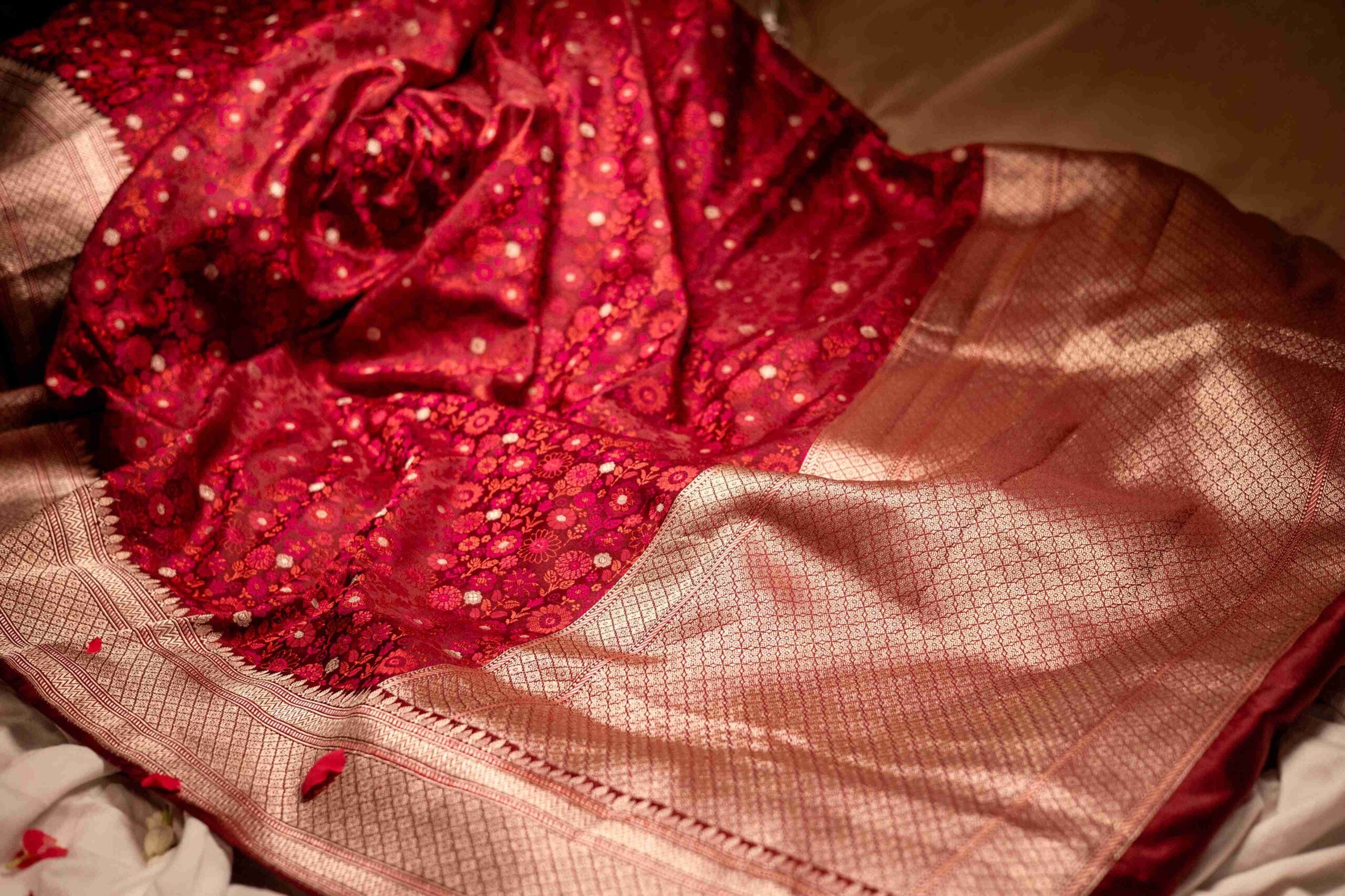 Maroon Tanchoi Banarasi saree with a floral weave and rose gold detailing.