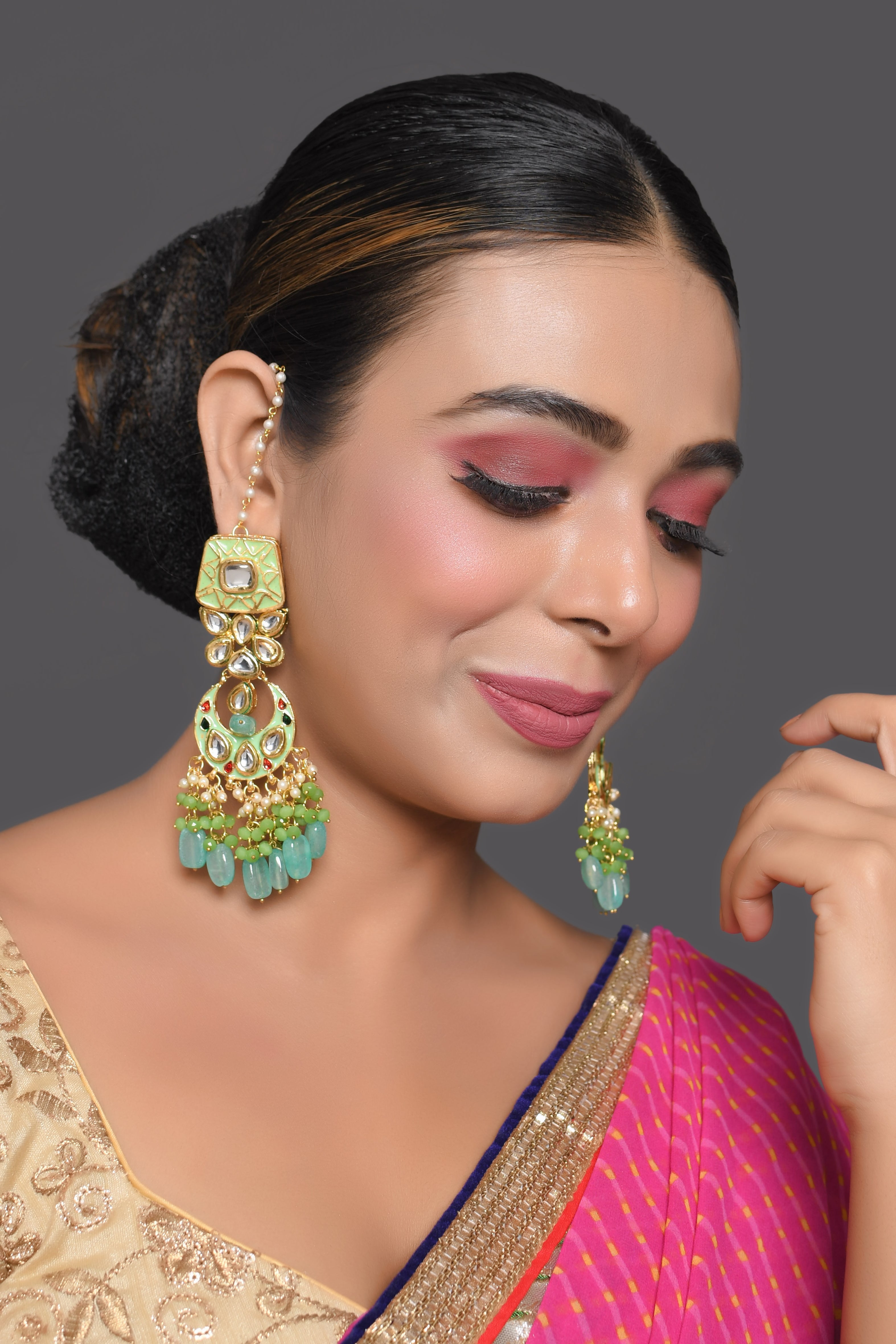 Gold toned Green Kundan studded & enameled handcrafted earrings