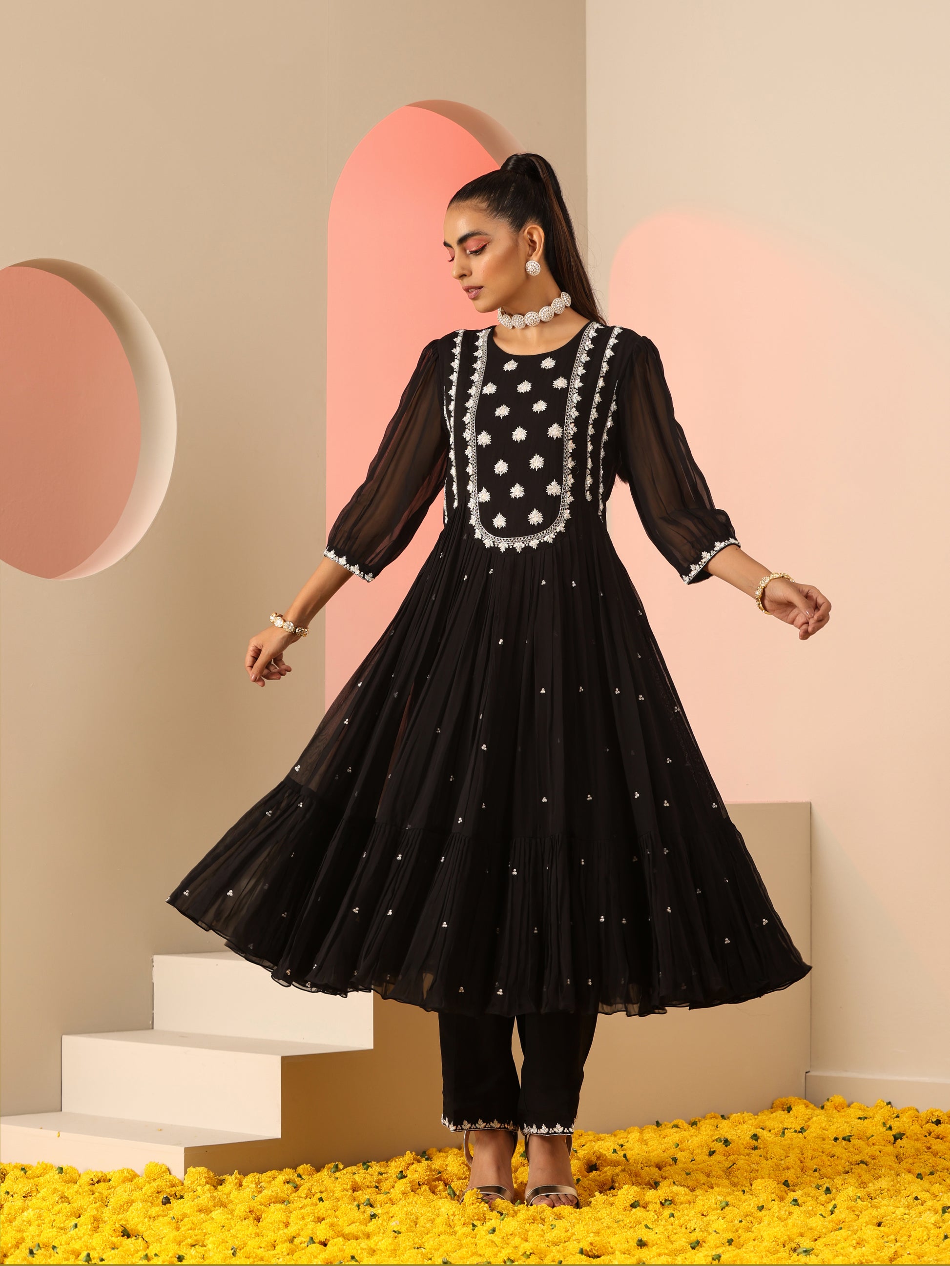 Black kurta set with white embroidery.