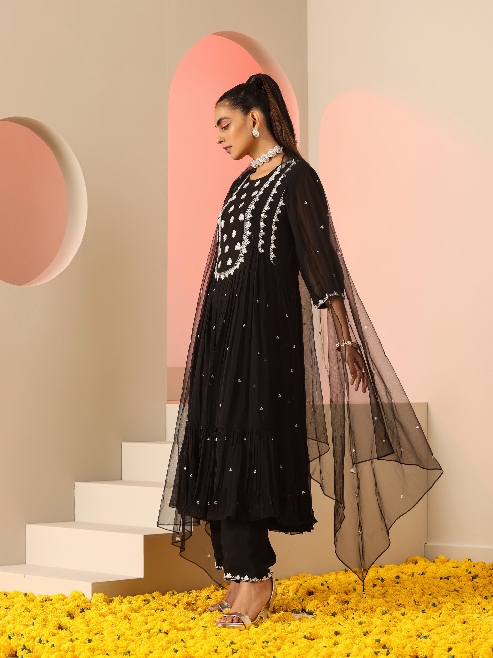 Black kurta set with white embroidery.