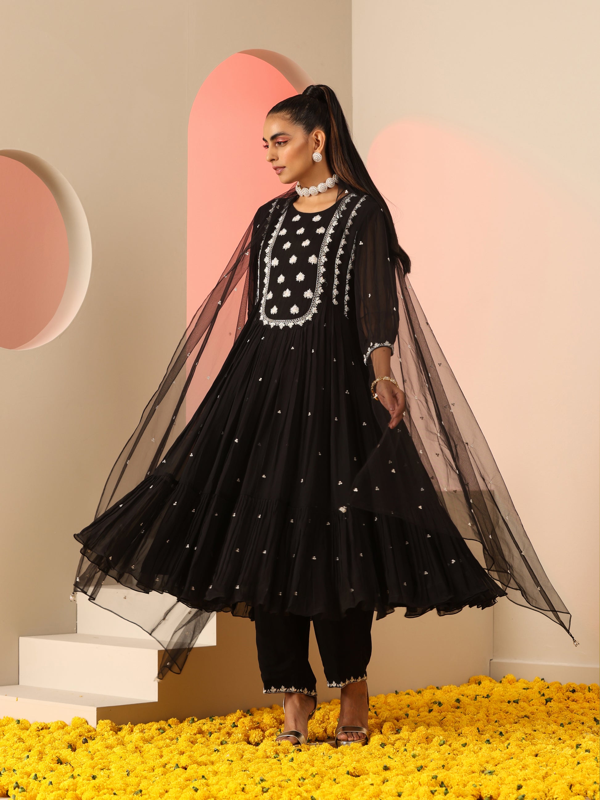 Black kurta set with white embroidery.