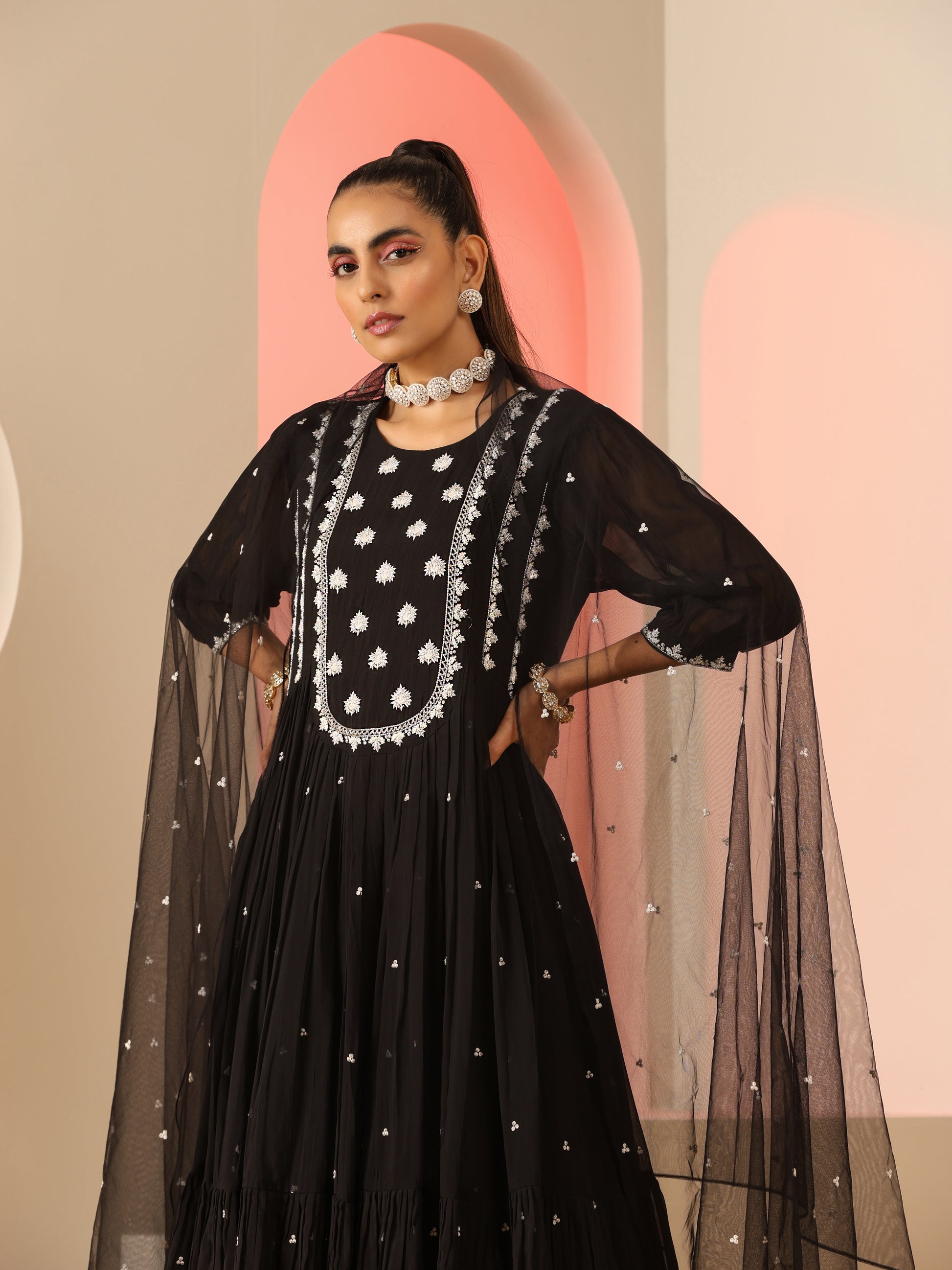 Black kurta set with white embroidery.