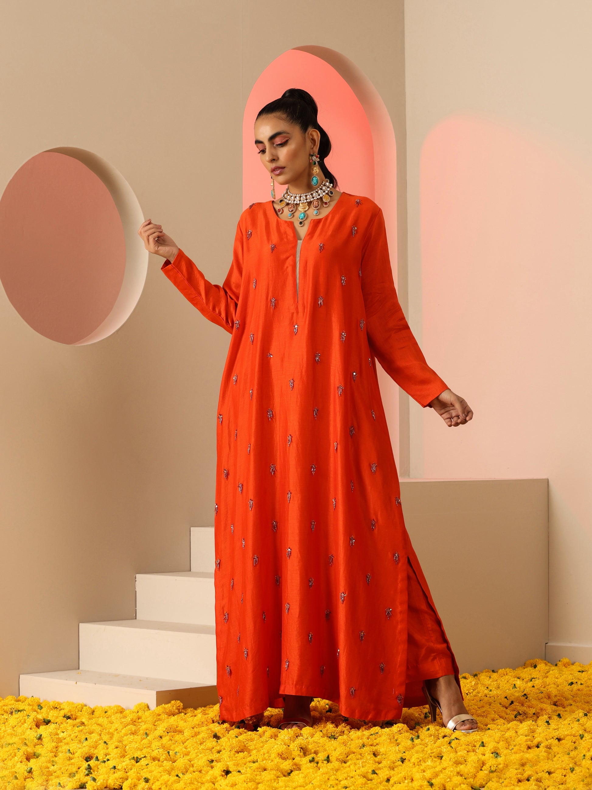 Orange tassel embroidered kurta set.