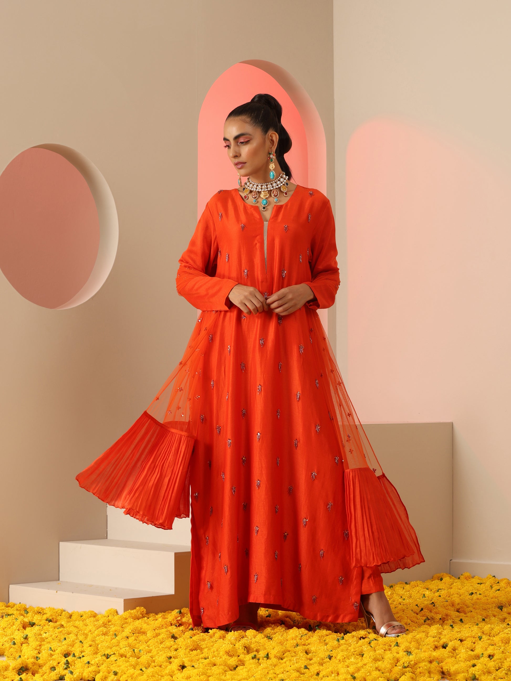 Orange tassel embroidered kurta set.