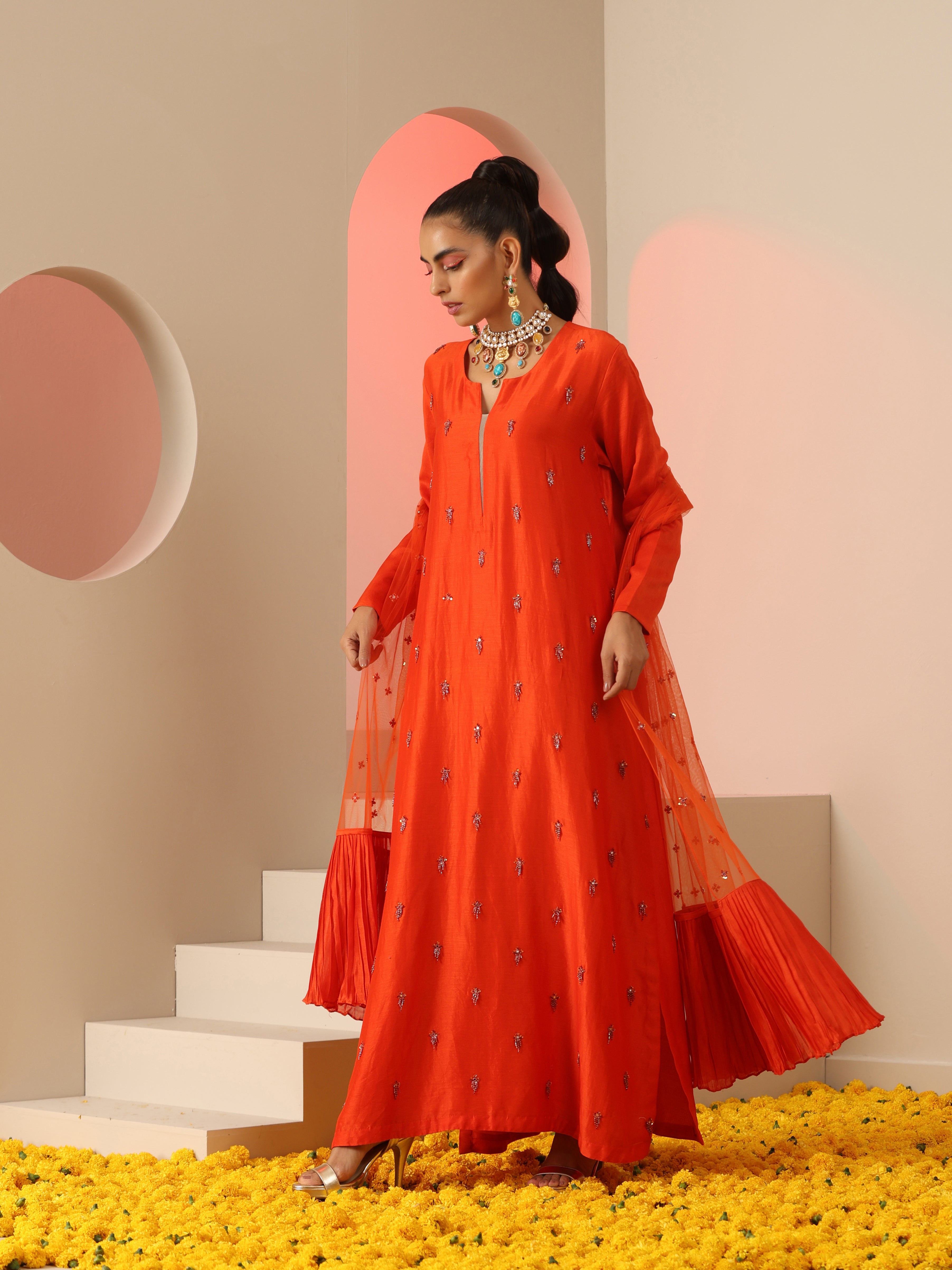 Orange tassel embroidered kurta set.