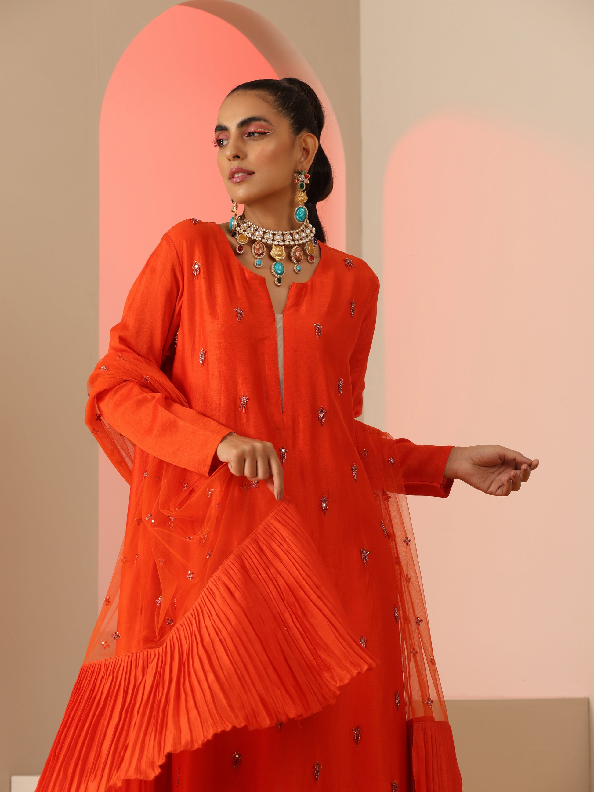 Orange tassel embroidered kurta set.