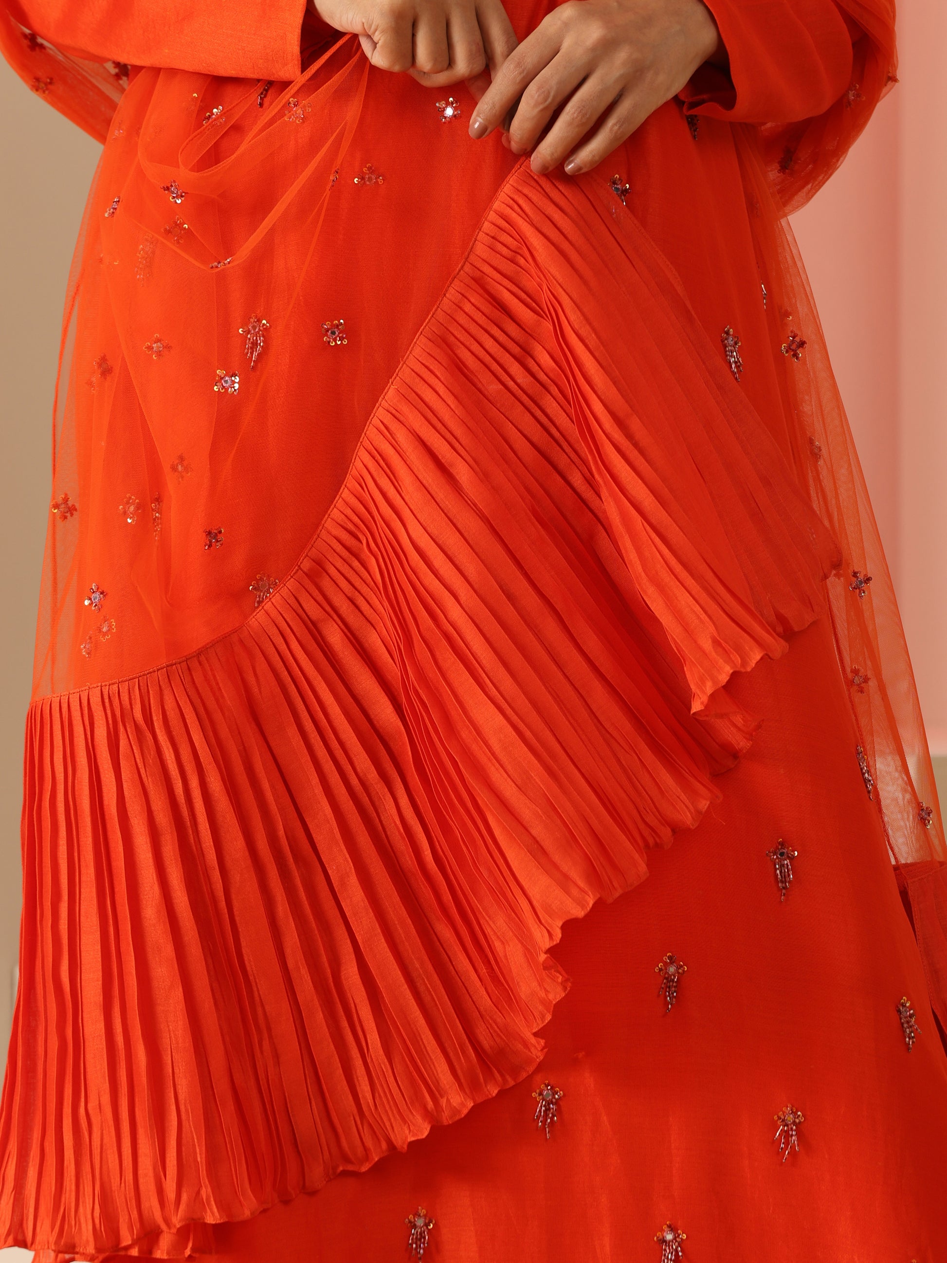 Orange tassel embroidered kurta set.