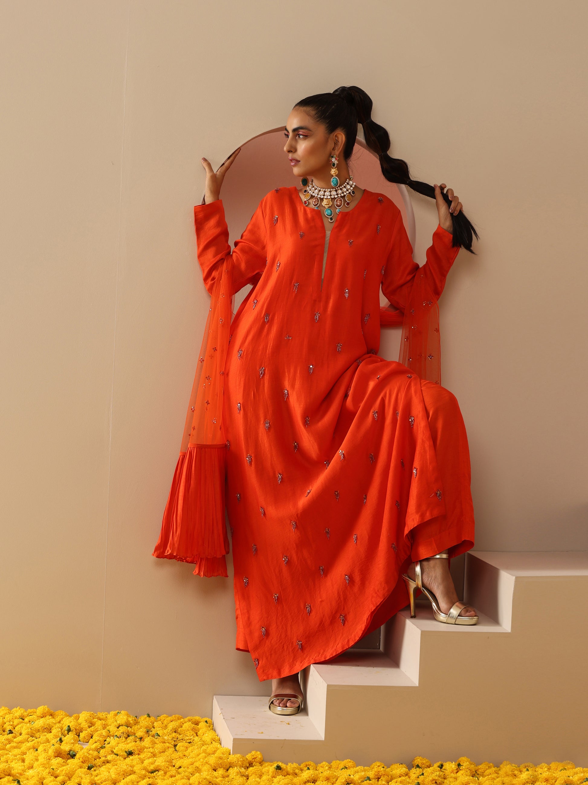 Orange tassel embroidered kurta set.