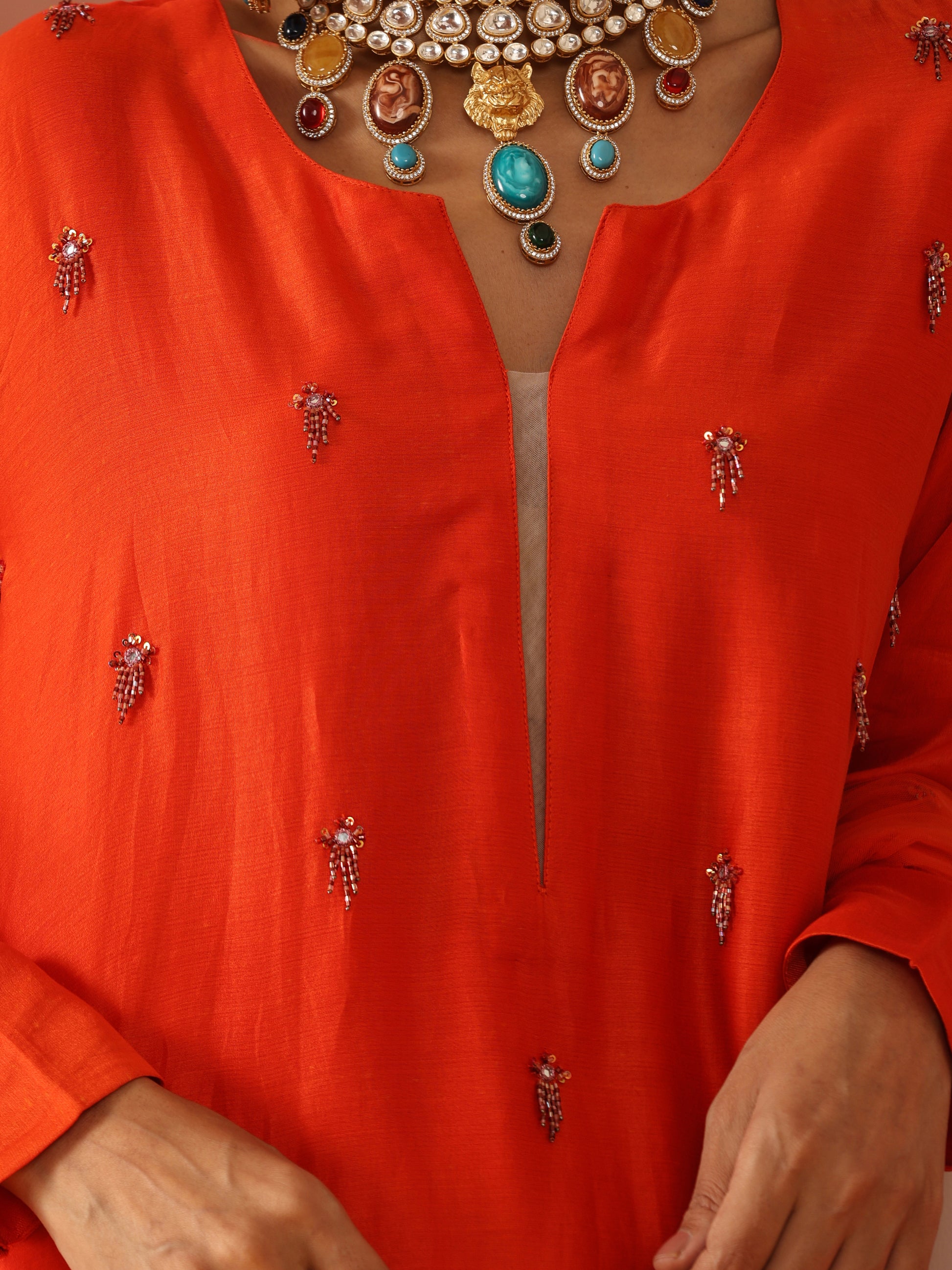 Orange tassel embroidered kurta set.